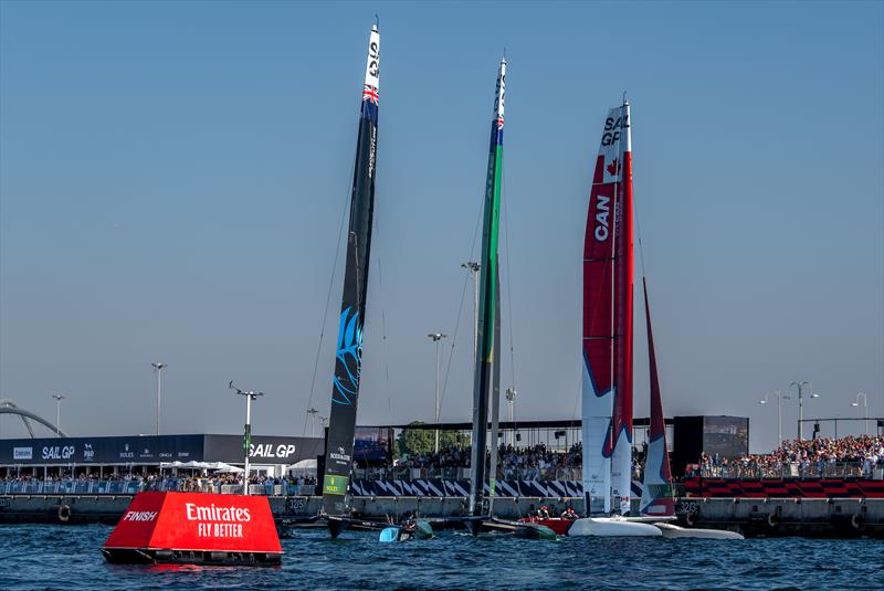 New Zealand SailGP Team leads from Australia and Canada SailGP Team as they cross the finish line in front of the Race Stadium in the final on Race Day 2 of the Emirates Sail Grand Prix 10th December  2023 photo copyright Ricardo Pinto/SailGP taken at Dubai Offshore Sailing Club and featuring the F50 class