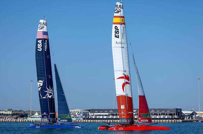 Spain SailGP Team helmed by Diego Botin and USA SailGP Team helmed by Taylor Canfield pass the Adrenaline Lounge on Race Day 1 of the Mubadala Abu Dhabi Sail Grand Prix presented by Abu Dhabi Sports Council photo copyright Felix Diemer for SailGP taken at  and featuring the F50 class