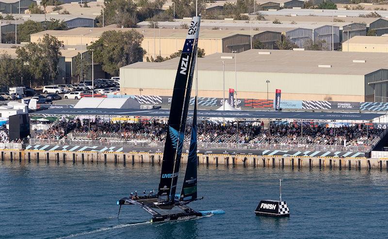 New Zealand SailGP Team helmed by Peter Burling crosses the finish line as it passes the grandstand in the SailGP Race Stadium on Race Day 2 of the Mubadala Abu Dhabi Sail Grand Prix presented by Abu Dhabi Sports Council - photo © Simon Bruty for SailGP