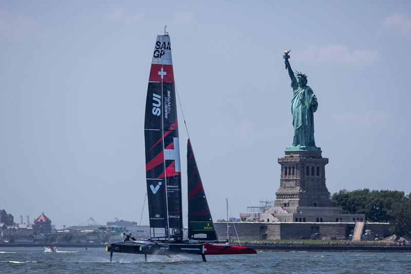 The Switzerland SailGP Team F50 catamaran passes the Statue of Liberty ahead of the Mubadala New York Sail Grand Prix in New York, USA - photo © Felix Diemer for SailGP