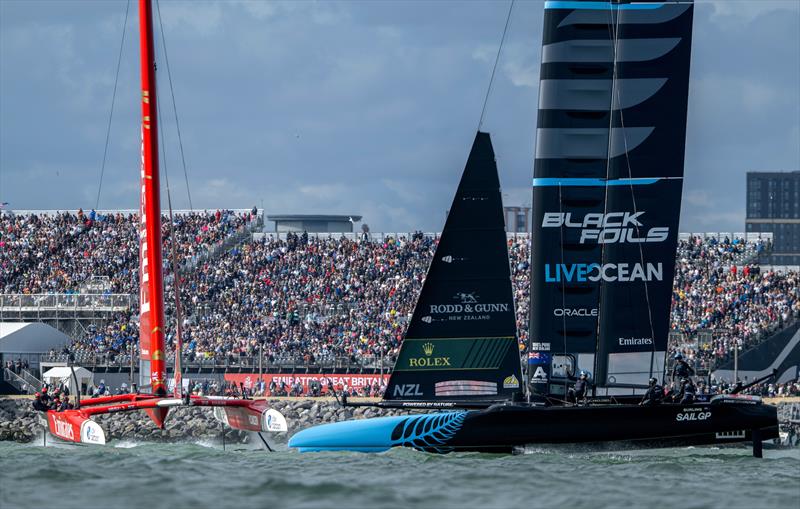 Emirates Great Britain SailGP Team helmed by Dylan Fletcher lead New Zealand SailGP Team helmed by Peter Burling as they sail pass the Grandstand on Race Day 2 of the Emirates Great Britain Sail Grand Prix in Portsmouth, UK - photo © Ricardo Pinto for SailGP