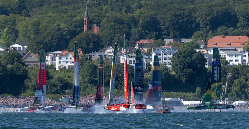 Emirates Great Britain SailGP Team helmed by Dylan Fletcher leads Germany SailGP Team presented by Deutsche Bank helmed by Erik Heil and the rest of the SailGP F50 catamaran fleet on Race Day 1 of the Germany Sail Grand Prix in Sassnitz, Germany - photo © Jonathan Nackstrand for SailGP