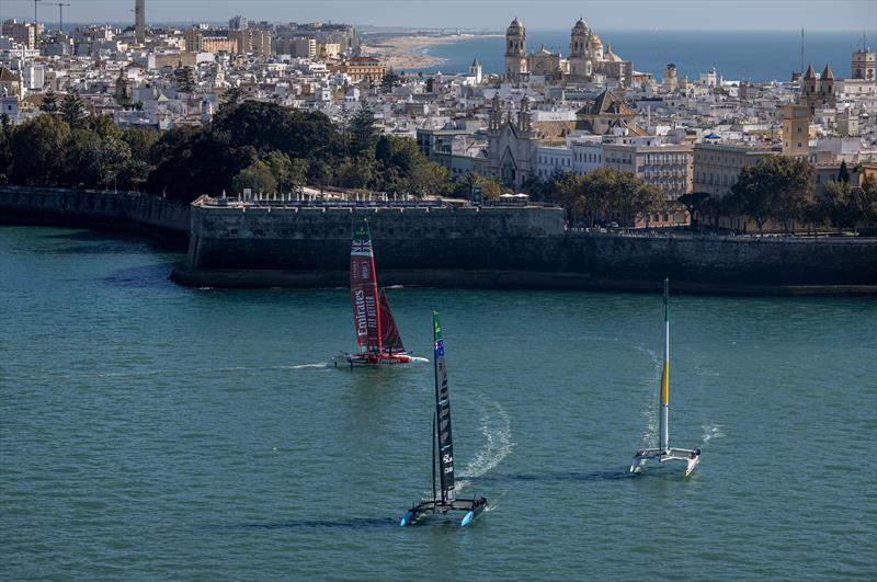 New Zealand SailGP Team Peter Burling leads Red Bull Italy SailGP Team and Emirates Great Britain SailGP Team past Cadiz during a practice session ahead of the DP World Spain Sail Grand Prix - photo © Samo Vidic for SailGP