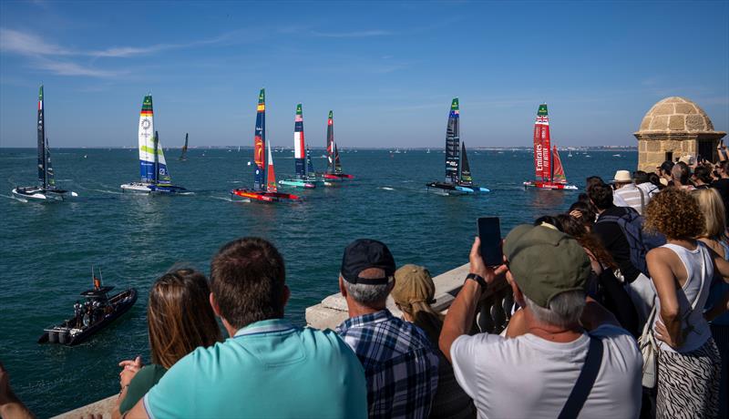 The SailGP F50 catamaran fleet led by Emirates Great Britain SailGP Team helmed by Dylan Fletcher races past the SailGP Race Stadium and Grandstand on Race Day 1 of the DP World Spain Sail Grand Prix photo copyright Charlie Raymond Kent for SailGP taken at  and featuring the F50 class