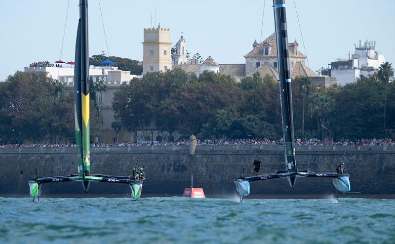 BONDS Flying Roos SailGP Team helmed by Tom Slingsby and New Zealand SailGP Team helmed by Peter Burling race side by side in front of the seawall during racing on Race Day 2 of the DP World Spain Sail Grand Prix held in Cadiz, Spain Sunday 5 October - photo © Ricardo Pinto for SailGP
