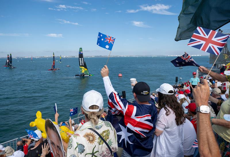 Spectators waving flags in the grandstand as they cheer the BONDS Flying Roos SailGP Team helmed by Tom Slingsby on Race Day 2 of the DP World Spain Sail Grand Prix held in Cadiz, Spain Sunday 5 October - photo © Jason Ludlow for SailGP