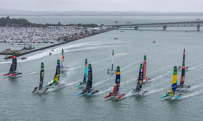 The SailGP F50 catamaran fleet sailing past the Auckland Harbour Bridge, on Race Day 1 of the ITM New Zealand Sail Grand Prix in Auckland, New Zealand - photo © Simon Bruty for SailGP