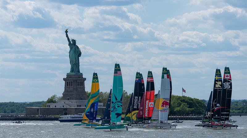 The SailGP F50 catamaran fleet sails by the Statue of Liberty on Race Day 2 of the Mubadala New York Sail Grand Prix - photo © Jason Ludlow for SailGP