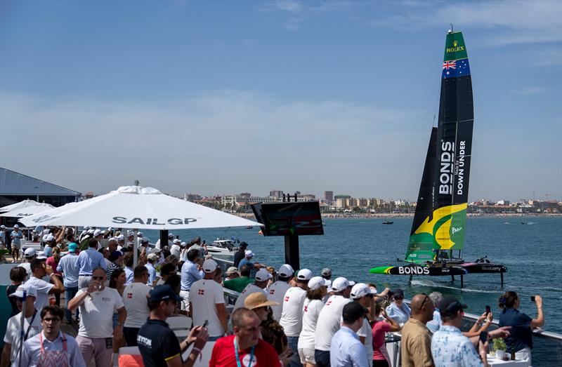 Spectators watch on from the Vela Beach Club as BONDS Flying Roos SailGP Team passes on Race Day 1 of the Spain Sail Grand Prix in Valencia, Spain - photo © Charlie Raymond Kent for SailGP
