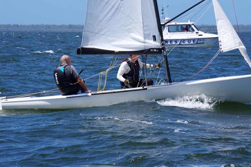 The oldest competitor in the FD fleet and four-times World Champion in the class, Ian McCrossin, partnered with Peter Bevis, takes Lupicus 60 AUS33 across the finish line into fourth place in race four of the Flying Dutchman 2026 Australian Championship - photo © Jeanette Severs