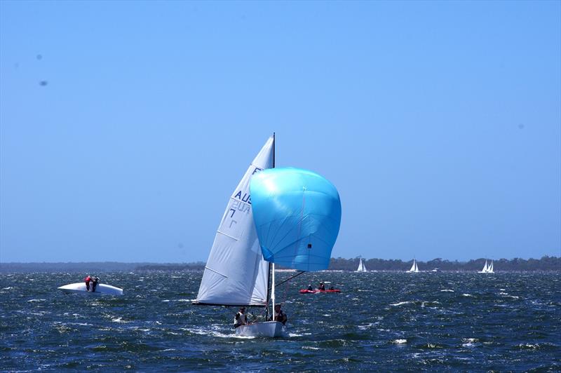 In the background, Michael Wood and Wayne Smith on Whoosh, upturned after achieving the leeward mark on the first leg, while Rafe Heale and Tom Watson on Power AUS7 approach the finish line with a strong lead in the Flying Dutchman AUS regatta race five - photo © Jeanette Severs