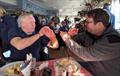 Finn sailors Cy Grisley and Simon Moss karate sailing over a shepherd's pie after the Keyhaven Yacht Club Rum Race &copy; Mark Jardine