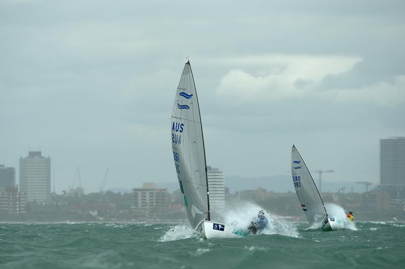 Oliver Tweddell (AUS) leading Josip Olujic (CRO) through a storm front on day 3 of ISAF Sailing World Cup Melbourne photo copyright Sport the library / Jeff Crow taken at Royal Melbourne Yacht Squadron and featuring the Finn class
