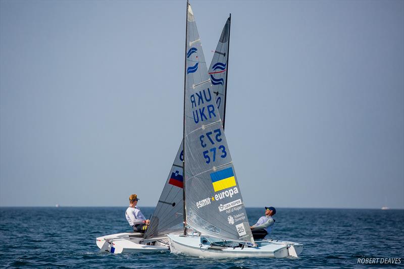 Jan Orel (SLO) crosses Georgii Paches (UKR) on day 3 of the Finn Silver Cup in Koper photo copyright Robert Deaves taken at  and featuring the Finn class