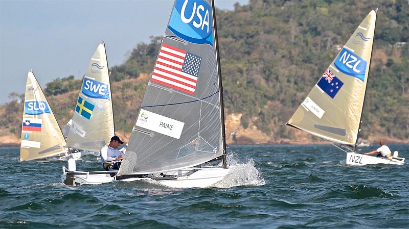 Caleb Paine lugs a 2kg onboard camera in the Finn Class Medal Race - Rio de Janeiro 2016 photo copyright Richard Gladwell taken at  and featuring the Finn class