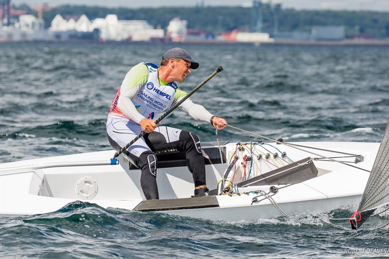 A Finn sailor grunts his boat downwind at the 2018 Hampel World Championships in Aarhus photo copyright Robert Deaves / IFA taken at  and featuring the Finn class