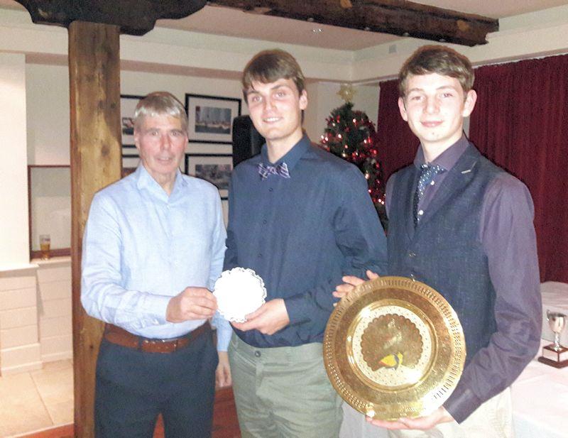 Daniel (L) and Harry Thompson collect the Travellers' Trophy for the Silver fleet (Daniel) and the India Trophy (Harry) from Class Chairman Neil Cramer at the Irish Fireball Class Prize Giving photo copyright Cormac Bradley taken at  and featuring the Fireball class