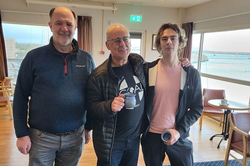 Colin Breen (centre) and Rory Power Breen (right) collect their Frostbite Mugs from Race Officer Cormac Bradley (left) - Viking Marine DMYC Frostbite Series 2 day 5 photo copyright Ian Cutliffe taken at Dun Laoghaire Motor Yacht Club and featuring the Fireball class