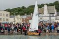 Boat Building Academy students launch their boats in Lyme Regis