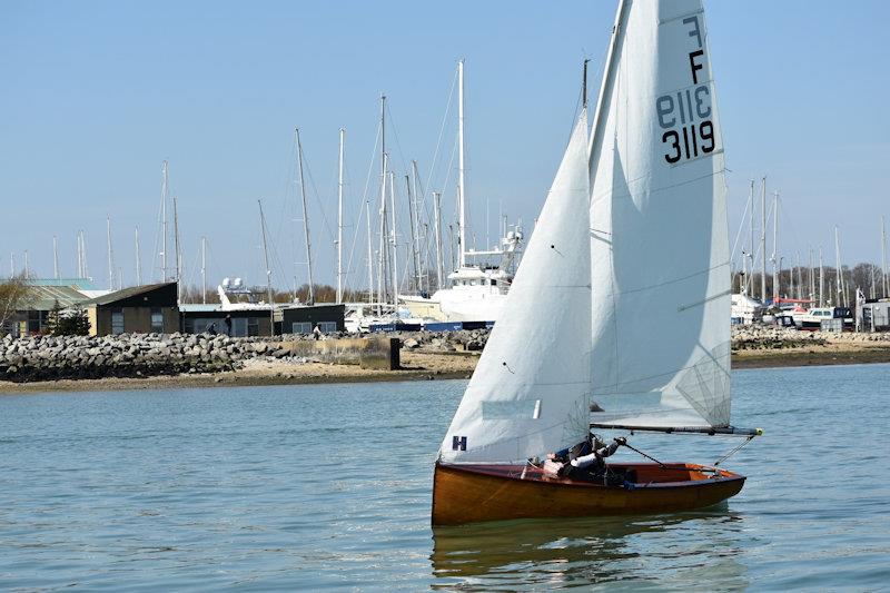 Still ghosting along in the lightest of breezes, the glorious varnished finish, the Hamble River and the old Fairey Marine works as a backdrop - photo © Dougal Henshall