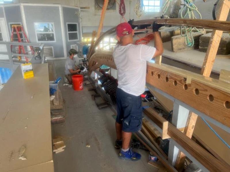 Hull #7 Tyler and Marcos laminating bridge rails - photo © Michael Rybovich & Sons