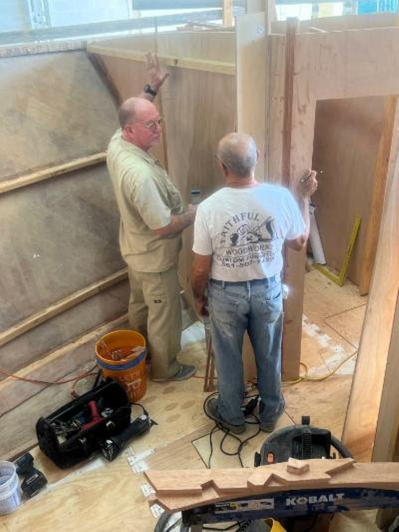 Hull #8 Brian R and Luis installing forward cabin joinery - photo © Michael Rybovich & Sons
