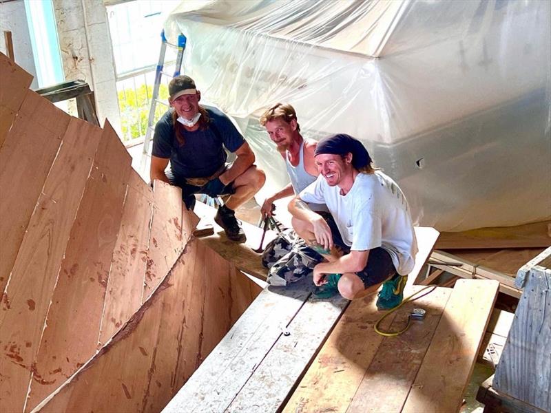 Hull #9 - Scott, Flipper and Daniel glue the last plank - photo © Michael Rybovich & Sons