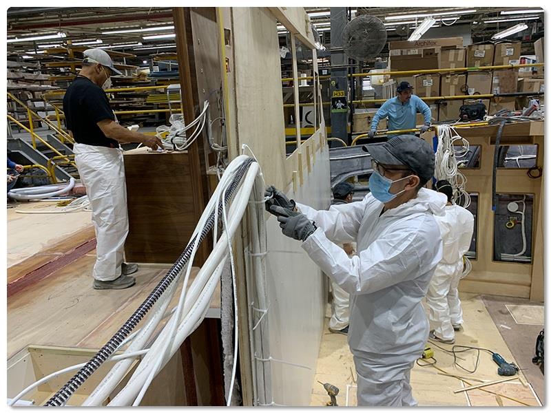 Salomon Lopez is focused on installing electrical cabling - photo © Viking Yachts