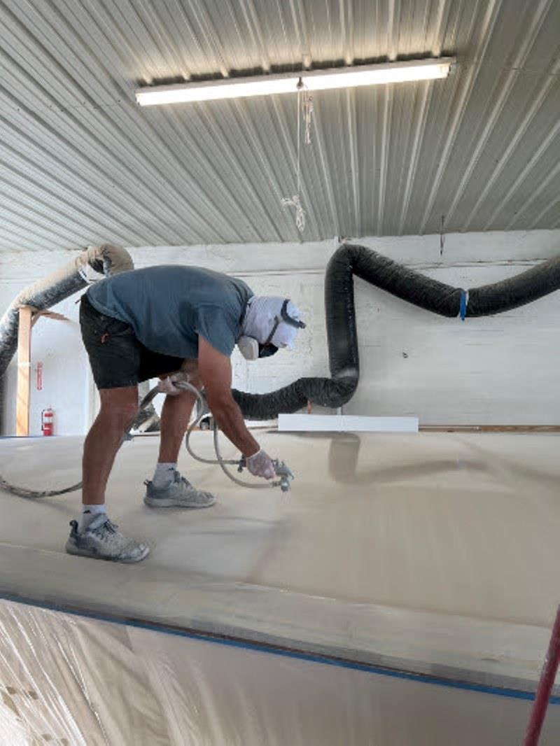 Hull #7 - Bernard priming foredeck - photo © Michael Rybovich & Sons