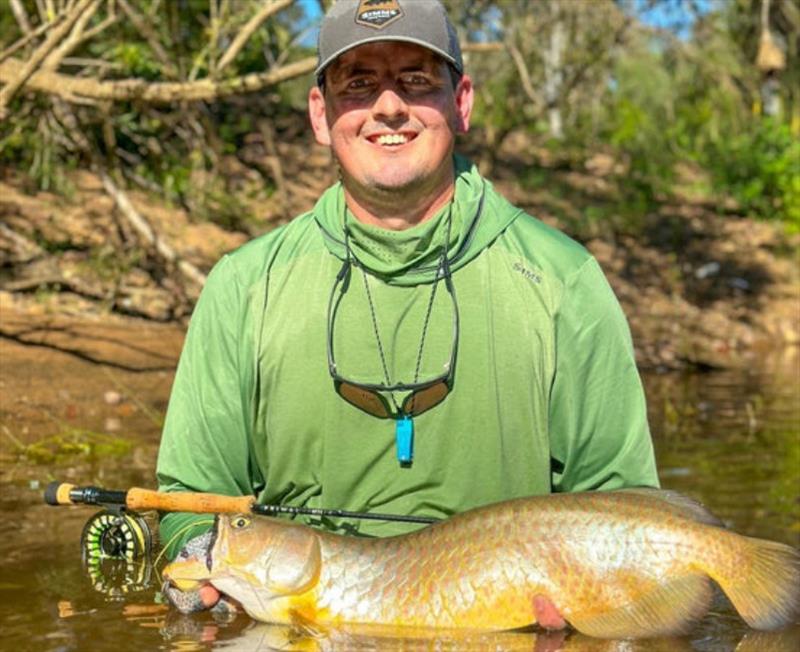Fly fishing guru, Josh Power, getting up close and personal with a ripper saratoga photo copyright Fisho's Tackle World taken at  and featuring the Fishing boat class