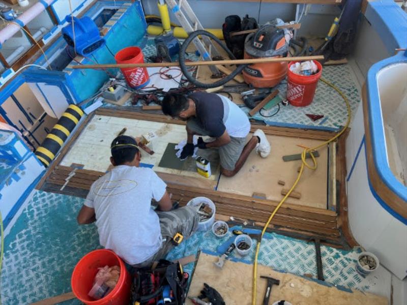 Hull #8 - Elvin and Juan on cockpit planking - photo © Michael Rybovich & Sons
