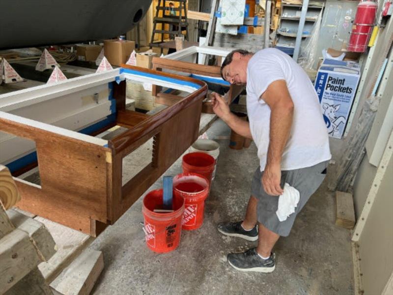Hull #8 - Clarke varnishing dinette seats - photo © Michael Rybovich & Sons