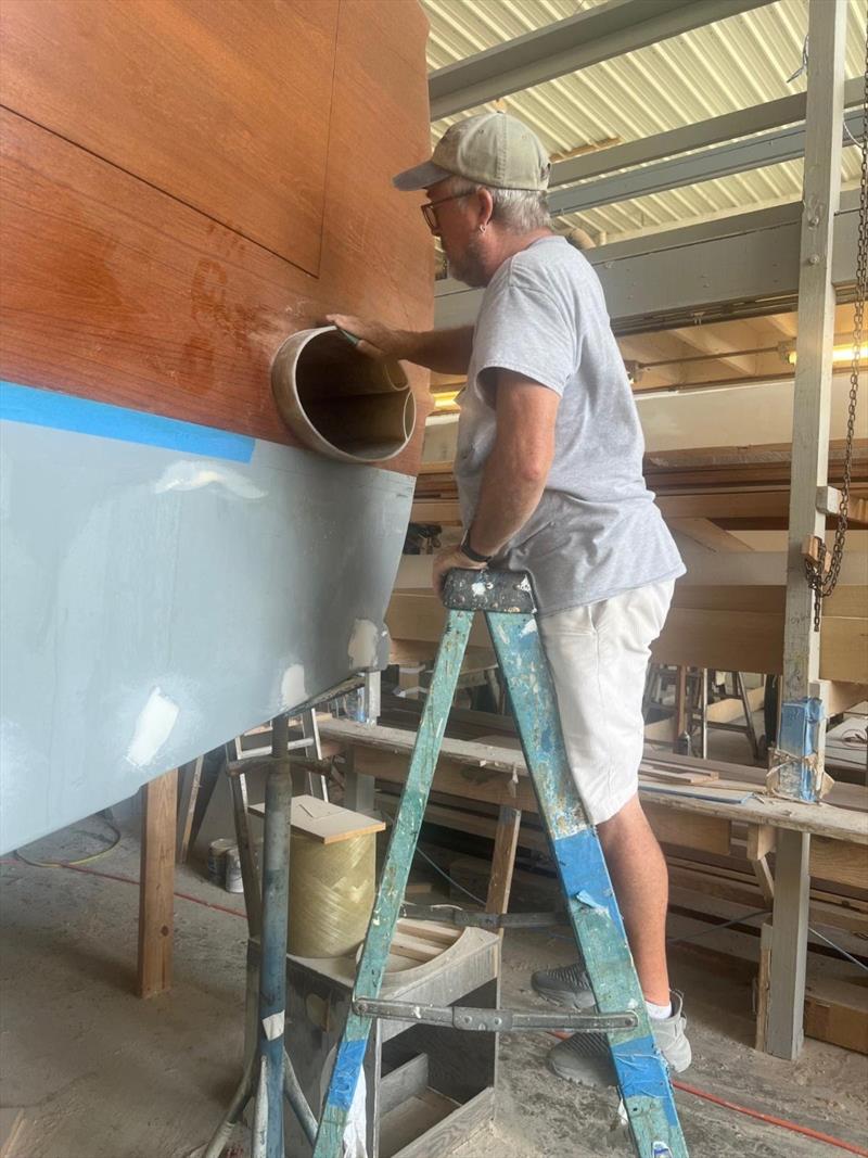 Hull #9 - John finishing transom exhaust - photo © Michael Rybovich & Sons