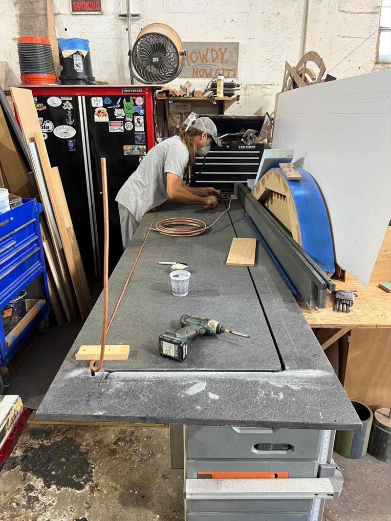 Hull #9 - Paul on freezer heat strip installation - photo © Michael Rybovich & Sons