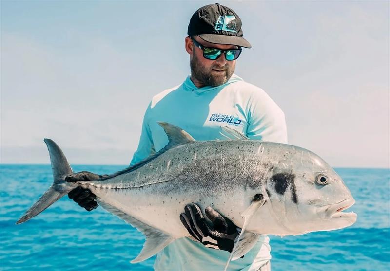Shaun, the skipper of Saltwater Playground Charters with a recent GT capture from the offshore shoal country photo copyright Fisho's Tackle World Hervey Bay taken at  and featuring the Fishing boat class