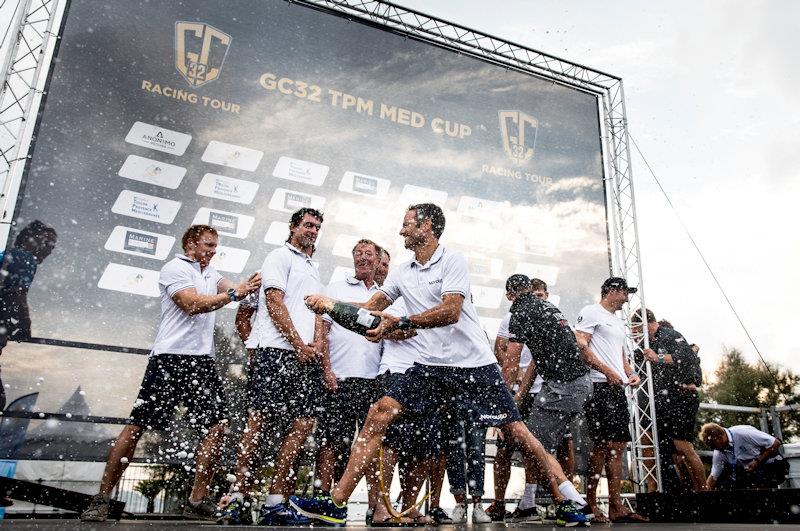 Franck Cammas dowses his NORAUTO team at the GC32 TPM Med Cup photo copyright Sailing Energy / GC32 Racing Tour taken at  and featuring the GC32 class