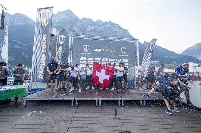 Alinghi shoot off the champagne at this afternoon's prizegiving at the Fraglia Vela Riva - 2019 GC32 Riva Cup photo copyright Sailing Energy / GC32 Racing Tour taken at  and featuring the GC32 class