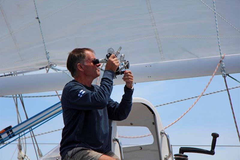 Tapio taking advantage of the clear skies to take a Noon sun sight - Golden Globe Race photo copyright Peter Foerthmann / Windpilot and Les Gallagher / Fishpics / PPL taken at  and featuring the Golden Globe Race class