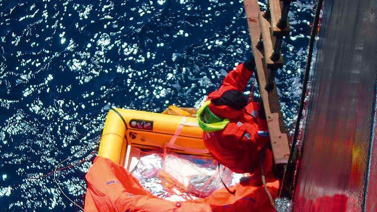 Tapio Lehtinen climbs onboard the Hong Kong-flagged bulk carrier Darya Gayatri after spending 24 hours at sea in his liferaft photo copyright Anglo Eastern taken at  and featuring the Golden Globe Race class