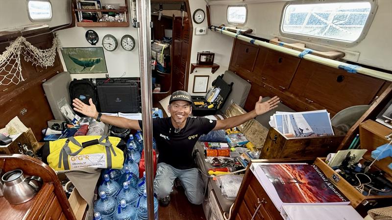 Canadian skipper Isa Rosli is all smiles after passing his GGR safety inspection aboard the OE 32 Olleanna. Every piece of mandatory equipment is still spread throughout the cabin—one major milestone completed, with the final packing still to come photo copyright JJ / GGR2026 taken at  and featuring the Golden Globe Race class