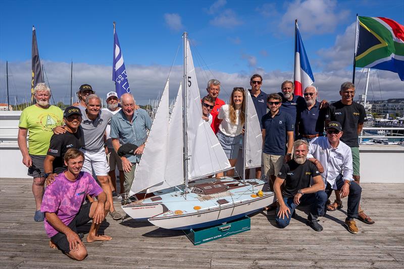 GGR2026 skippers and guests gather around a scale model of Donald Crowhurst's legendary trimaran Teignmouth Electron - photo © Rob Havill / GGR