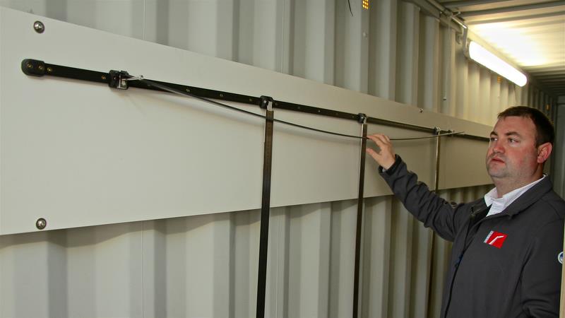 Hall Spars - Hayden Whitburn demonstrates a batten under bend test. Normally a specified weight is hung from the batten and the bend measured against the three rollers in adjustable position on the track photo copyright Richard Gladwell taken at  and featuring the  class