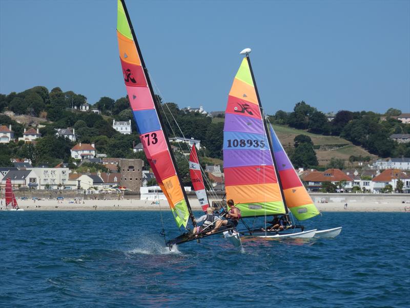 Youth team, Leo Marshall and Tom Holden, flying their Hobie 16 in the bay during the Love Wine 'Summer Breeze' Series in Jersey photo copyright Elaine Burgis taken at Royal Channel Islands Yacht Club and featuring the Hobie 16 class