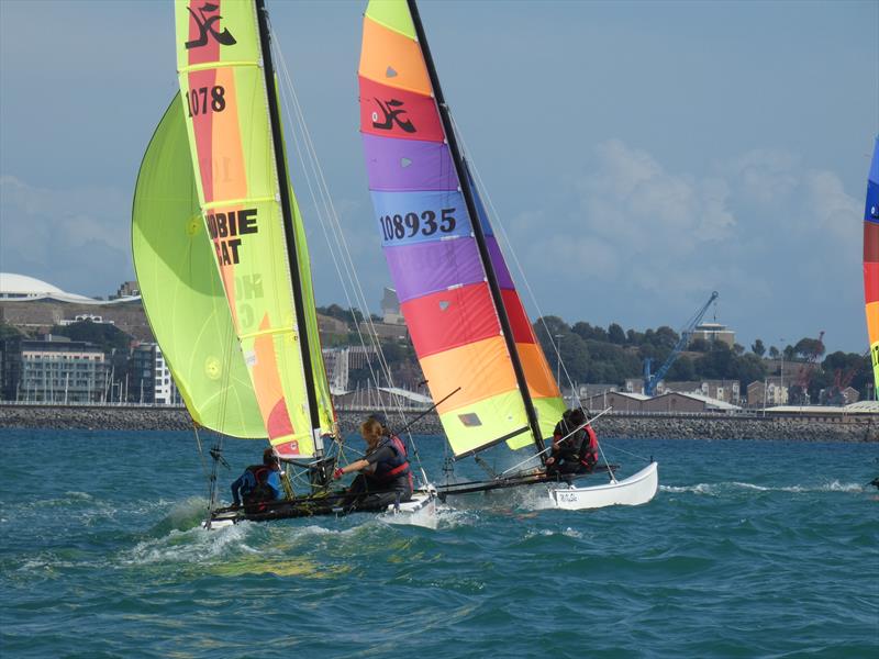 Hobie Dragoon Juniors Else Blakeley and crew (foreground) during the RCIYC Hobie Fleets Love Wine 'Summer Breeze' series photo copyright Elaine Burgis taken at Royal Channel Islands Yacht Club and featuring the Hobie Dragoon class