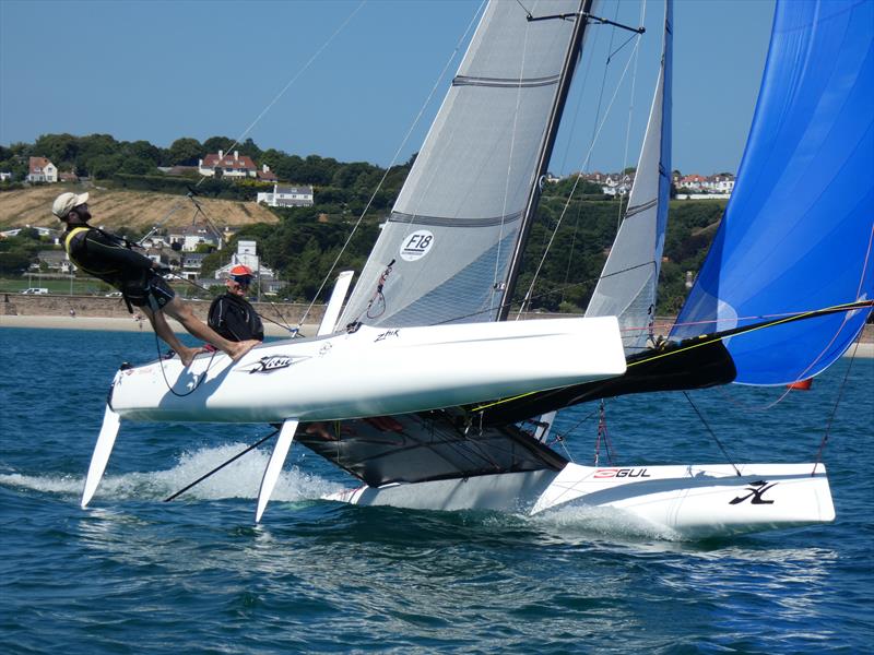 Darren Stower and Julian Adamson flying high on a Wildcat during the Love Wine 'Summer Breeze' Series in Jersey photo copyright Elaine Burgis taken at Royal Channel Islands Yacht Club and featuring the Hobie Wild Cat class