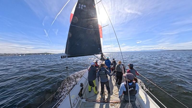 Jonathan McKee (left, in yellow bibs) discusses downwind breeze with Jen Glass (second from left), Cascadia Sailing's tactician photo copyright Cascadia Sailing Collection taken at Seattle Yacht Club and featuring the IC37 class
