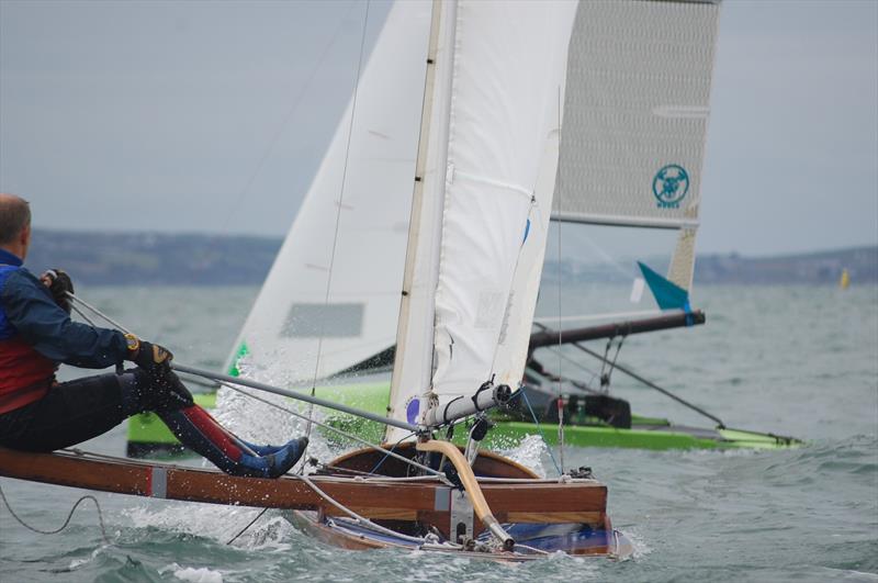 The international Canoes were strong on being inclusive for all genres of Canoe, including the older classics. Michael Briggs in a 50 year old woodie could often be seen mixing it with much more modern versions and he would also finish the windy races! - photo © David Henshall