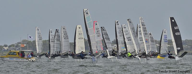 The fleet on the foils for the start of Race 5 photo copyright Emily Scott Images taken at Royal Queensland Yacht Squadron and featuring the International Moth class