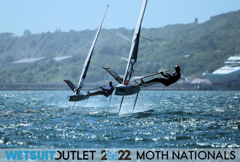 Brad Funk flying high while Simon Hiscocks watches on Day 3 of the 2022 Wetsuit Outlet UK Moth Class Nationals at the WPNSA photo copyright Mark Jardine / IMCA UK taken at Weymouth & Portland Sailing Academy and featuring the International Moth class