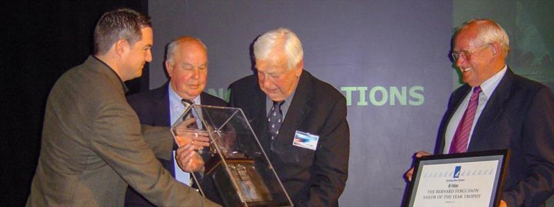 Mike Loft (sponsor's representative) presents the Sailor the Year trophy to (from left) John Street, Sir Tom Clark and Trevor Geldard in 2004  - photo © YNZ media